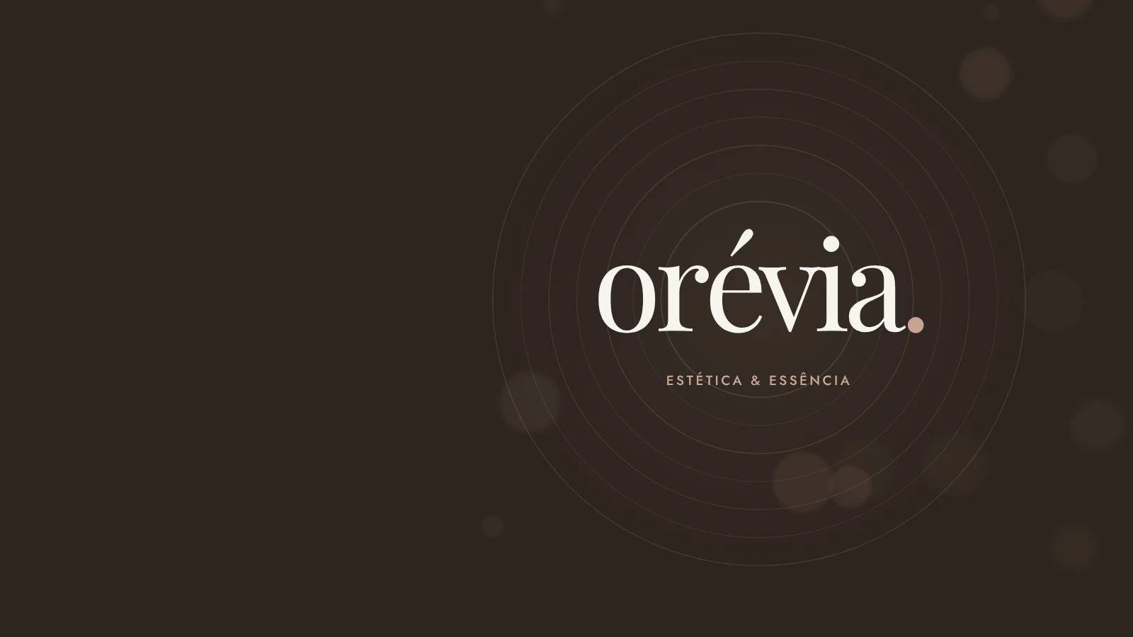O logotipo orévia., com o ponto rosé, no centro de ondas concêntricas de luz.